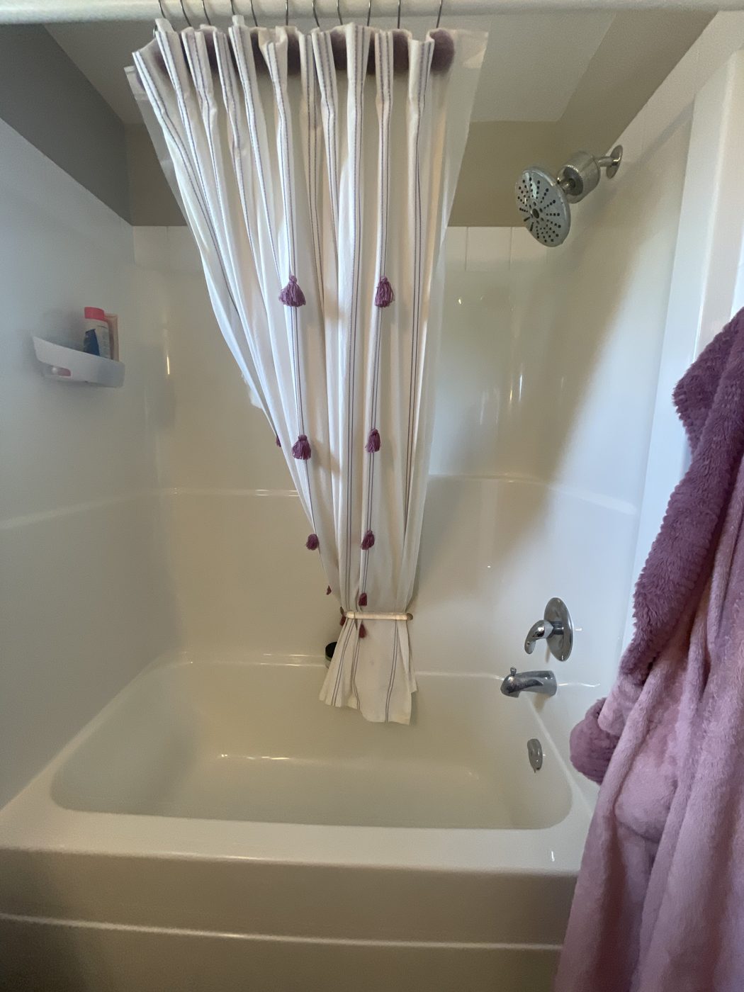 Sparkling clean white bathtub and shower surround